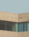 Close up of an artwork by Lance Corlett of a beige building corner with glass windows against a light blue sky